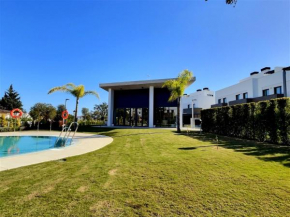Close to the marina and beaches of Sotogrande, experience sophistication in this contemporary four-bedroom frontline golf townhouse in the San Roque Club, San Roque